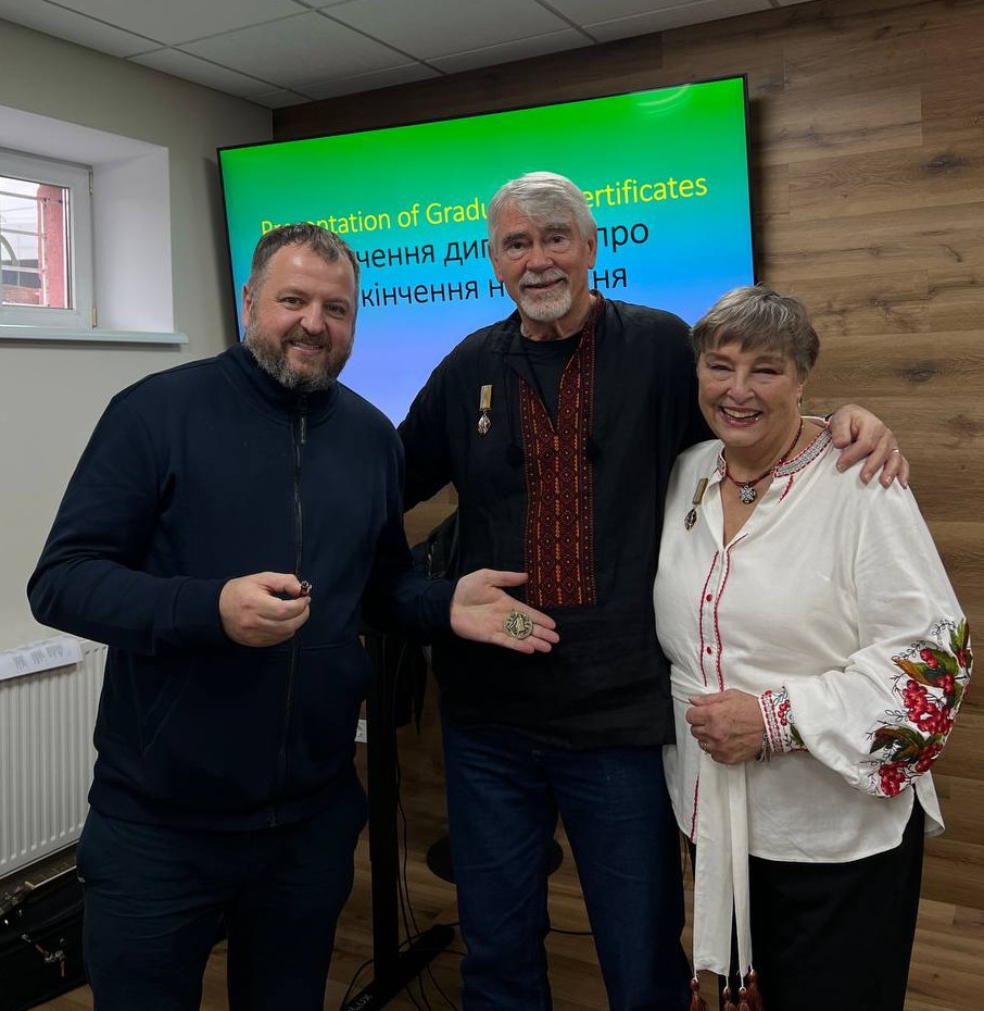 Chris and Rahnella with a Ukrainian ministry partner in a training room.