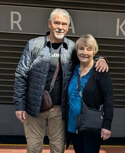 Chris and Rahnella at a train station during their travel.