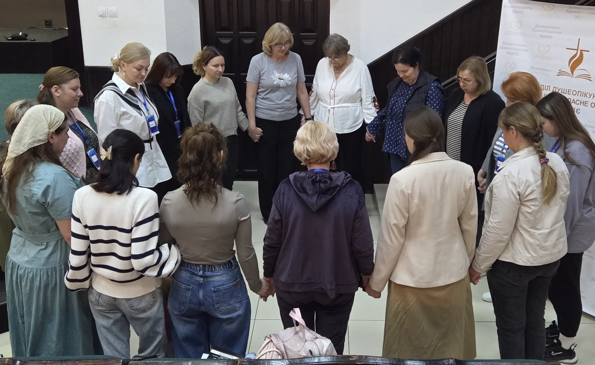 Rahnella joins women and ministry participants in a circle of prayer.